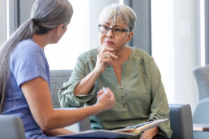 The senior adult woman listens carefully as the female doctor explains the benefits of CBD to her.